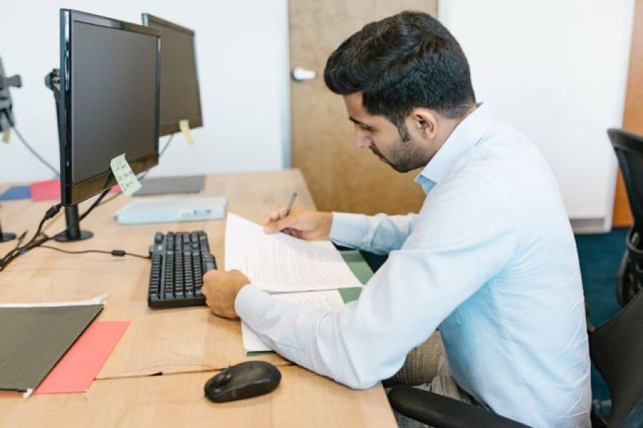 Labour advisor reviewing a client's paperwork at their desk